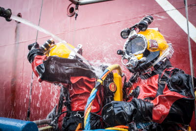 Coast Guard divers are flushed after a dive